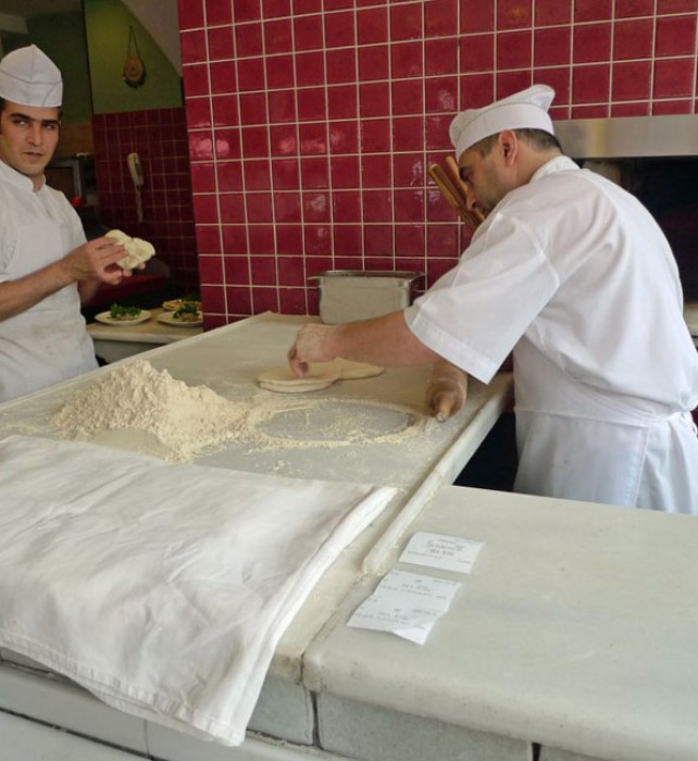 The baker bakes pita bread constantly at Ciya.