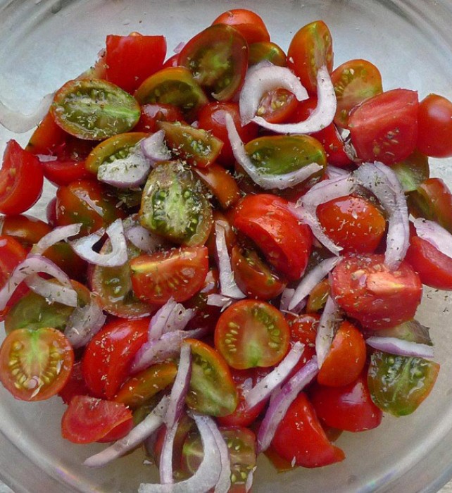 We devour copious amounts of tomatoes every day, simply dressed just with fruity olive oil and a sprinkling of dry oregano; onion rings and home-made capers are some favorite embellishments.